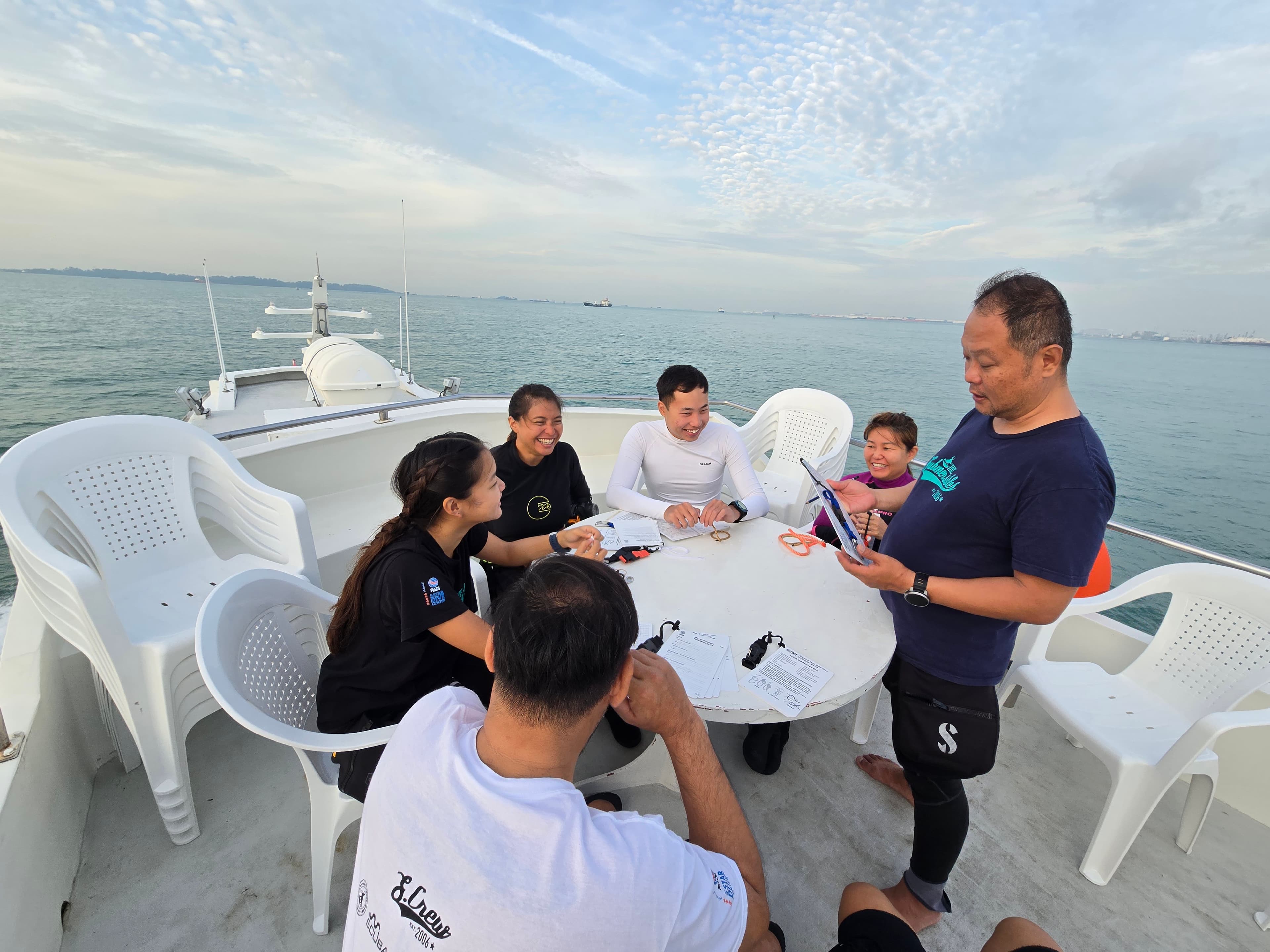 IDC candidates and instructor sharing a moment during on-water training